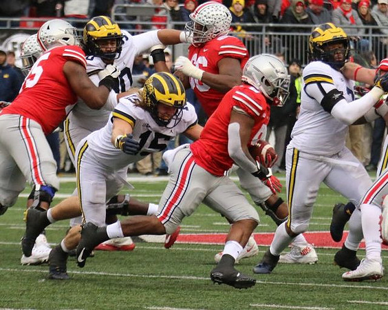 Bryan Mone (90), Chase Winovich (15), and Khaleke Hudson (7)