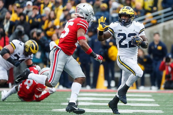 Ben Bredeson (74) and Karan Higdon (22)