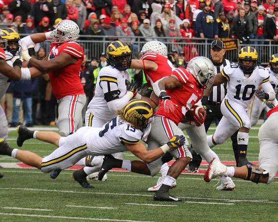 Chase Winovich (15) and Devin Bush (10)
