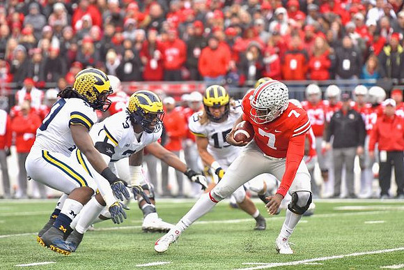 Devin Bush (10), Rashan Gary (3), and Chase Winovich (15)