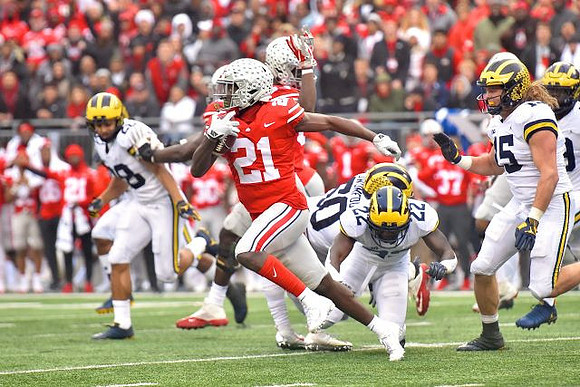 Brandon Watson (28), David Long (22), Michael Dwumfour (50), Chase Winovich (15), and Rashan Gary (3)