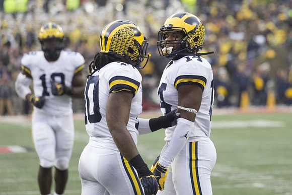 Kwity Paye (19), Devin Bush (10), and Josh Metellus (14)