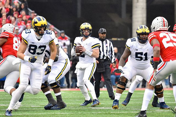 Zach Gentry (83), Michael Onwenu (50), Shea Patterson (2), and Cesar Ruiz (51)