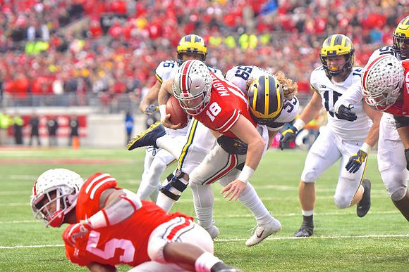 J'Marick Woods (26), Noah Furbush (59), Chase Winovich (15), and Michael Dwumfour (50)