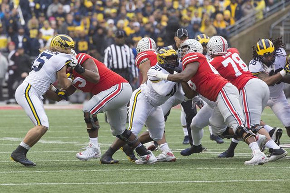 Chase Winovich (15), Michael Dwumfour (50), and Devin Gil (36)