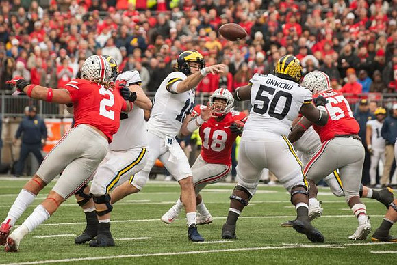 Brandon Peters (18) and Michael Onwenu (50)