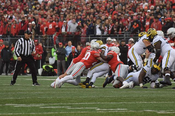 Karan Higdon (22), Cesar Ruiz (51), Ben Bredeson (74), and Michael Onwenu (50)