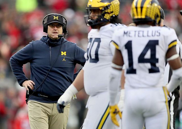 Jim Harbaugh, Bryan Mone (90), and Josh Metellus (14)