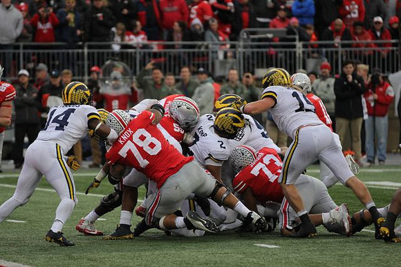 Josh Metellus (14), Carlo Kemp (2), Bryan Mone (90), and Chase Winovich (15)