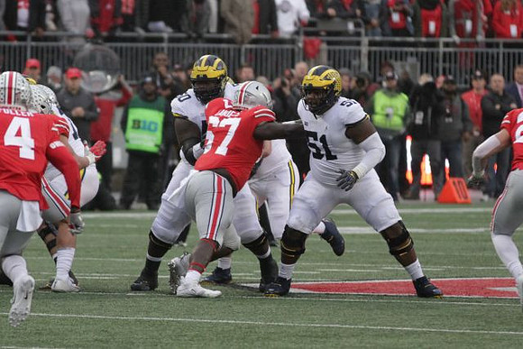 Michael Onwenu (50) and Cesar Ruiz (51)