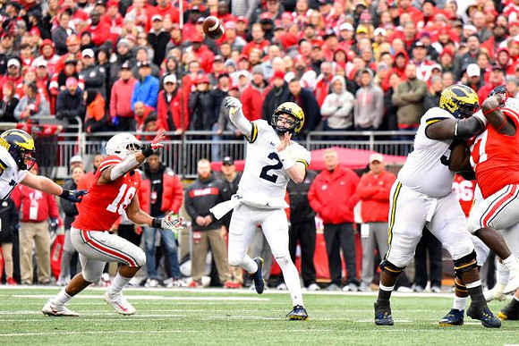 Shea Patterson (2) and Michael Onwenu (50)