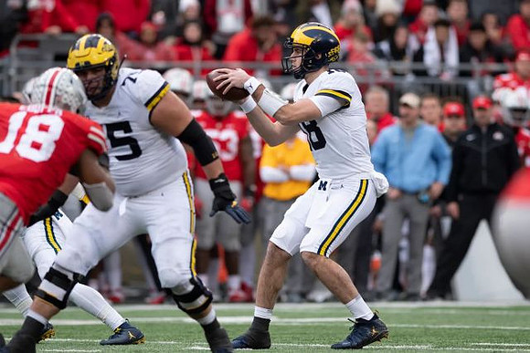 Jon Runyan Jr. (75) and Brandon Peters (18)