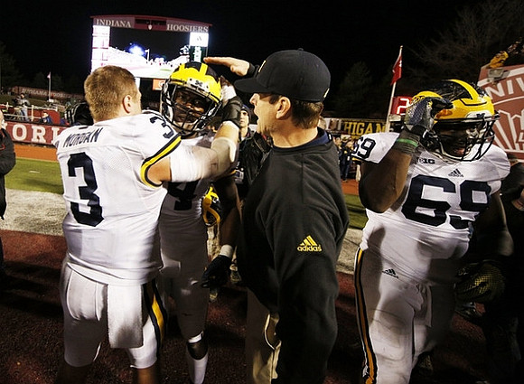 Desmond Morgan (3), Delano Hill (44), Jim Harbaugh, and Willie Henry (69)