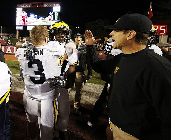 Desmond Morgan (3), Delano Hill (44), Jim Harbaugh, and Willie Henry (69)