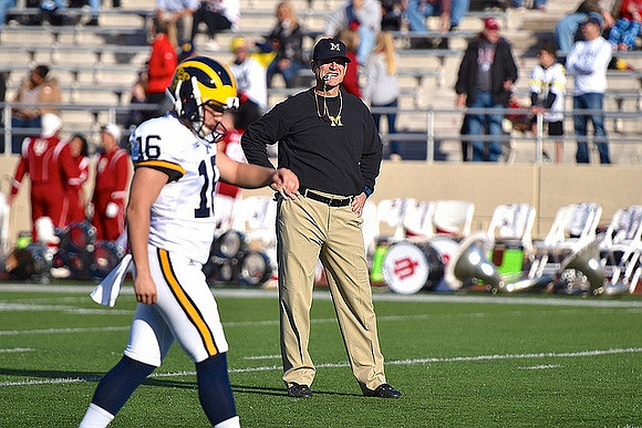 Garrett Moores (16) and Jim Harbaugh