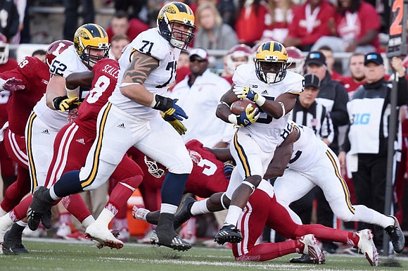 Mason Cole (52), Ben Braden (71), and Jabrill Peppers (5)