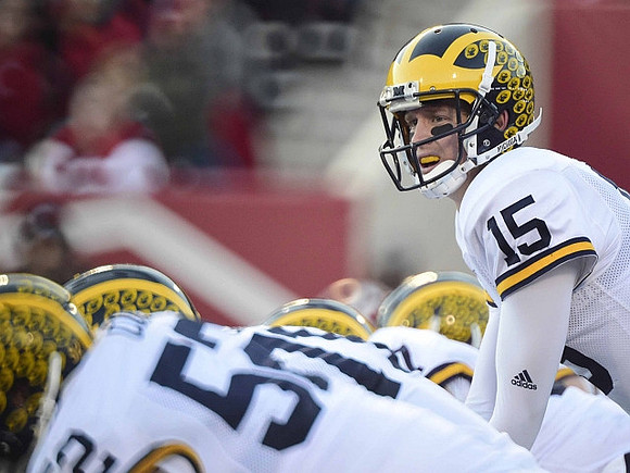 Mason Cole (52) and Jake Rudock (15)