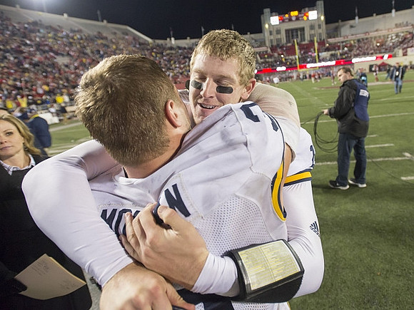 Desmond Morgan (3) and Jake Rudock (15)