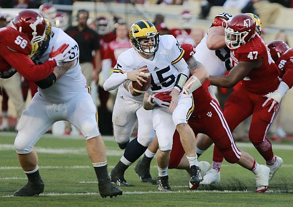 Kyle Kalis (67), Jake Rudock (15), and Mason Cole (52)