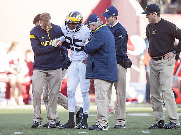 Dymonte Thomas (25) and Jim Harbaugh