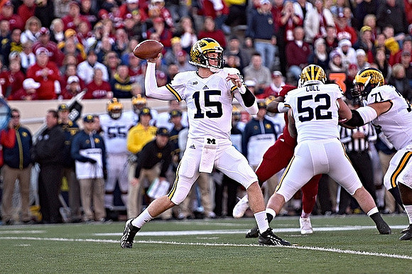 Jake Rudock (15), Mason Cole (52), and Ben Braden (71)
