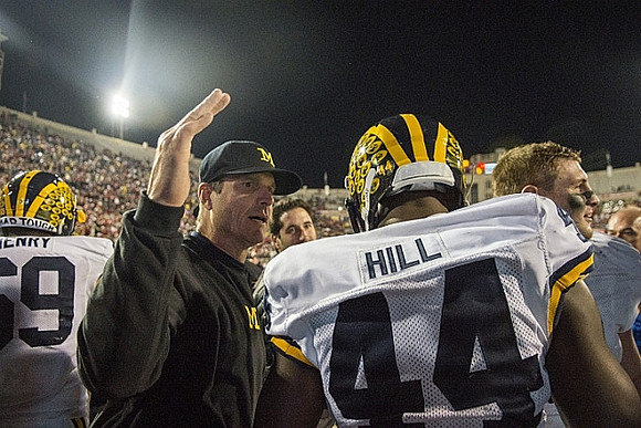 Willie Henry (69), Jim Harbaugh, and Delano Hill (44)