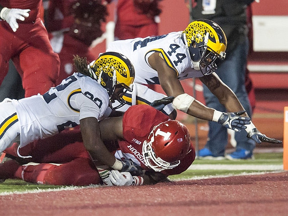 Jarrod Wilson (22) and Delano Hill (44)