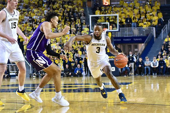Jon Teske (15) and Zavier Simpson (3)