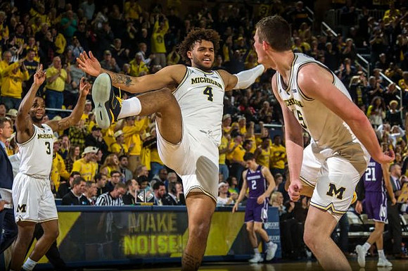 Zavier Simpson (3), Isaiah Livers (4), and Jon Teske (15)