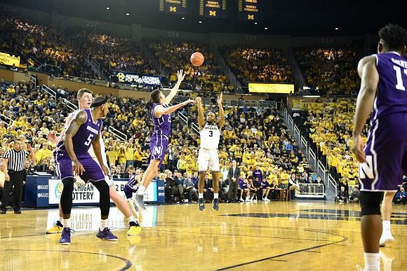 Jon Teske (15) and Zavier Simpson (3)