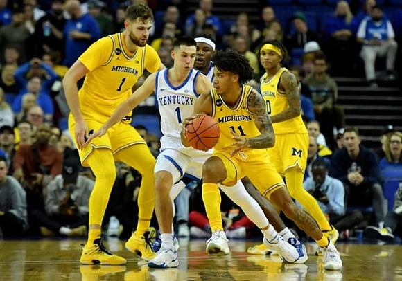 Hunter Dickinson (1), Isaiah Barnes (11), and Dug McDaniel (0)