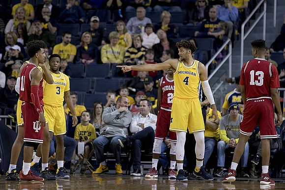 Zavier Simpson (3) and Isaiah Livers (4)