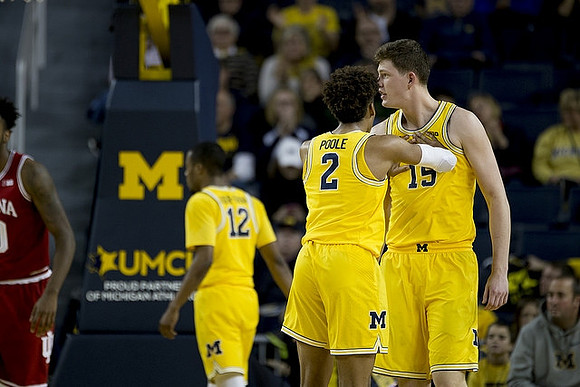 Muhammad-Ali Abdur-Rahkman (12), Jordan Poole (2), and Jon Teske (15)