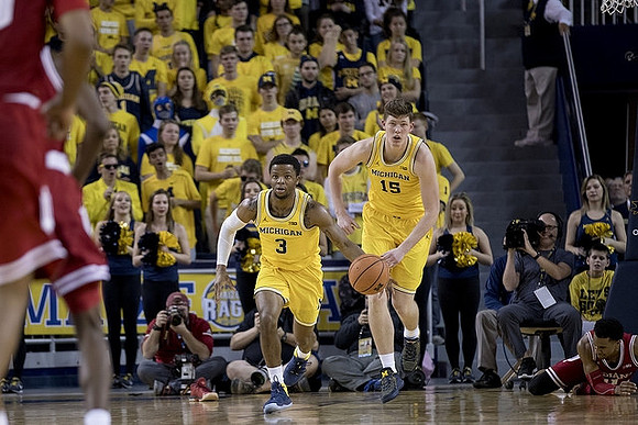 Zavier Simpson (3) and Jon Teske (15)