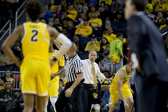 Jordan Poole (2), John Beilein, and Duncan Robinson (22)