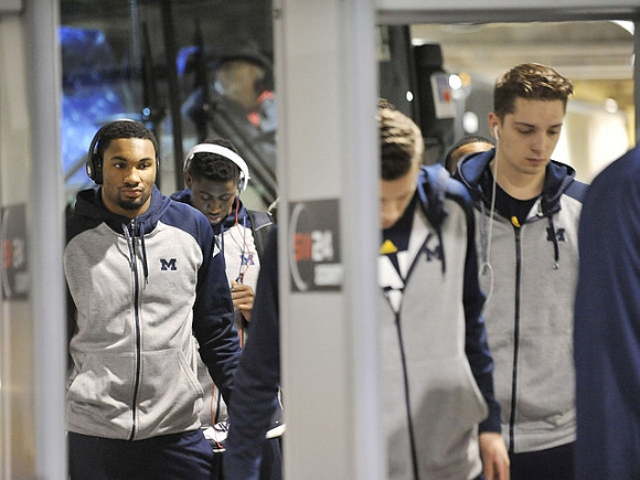 Zak Irvin (21), Caris LeVert (23), and Mark Donnal (34)