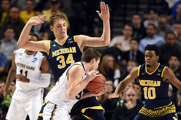 Mark Donnal (34) and Derrick Walton Jr. (10)
