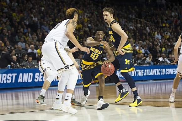 Derrick Walton Jr. (10) and Mark Donnal (34)