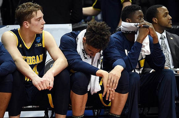 Mark Donnal (34), D.J. Wilson (5), and Caris LeVert (23)