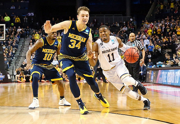 Derrick Walton Jr. (10) and Mark Donnal (34)