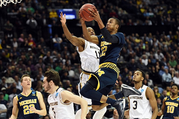Duncan Robinson (22), Muhammad-Ali Abdur-Rahkman (12), and Derrick Walton Jr. (10)