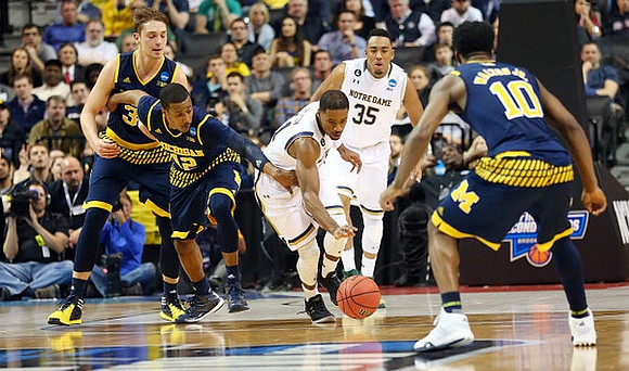 Mark Donnal (34), Muhammad-Ali Abdur-Rahkman (12), and Derrick Walton Jr. (10)