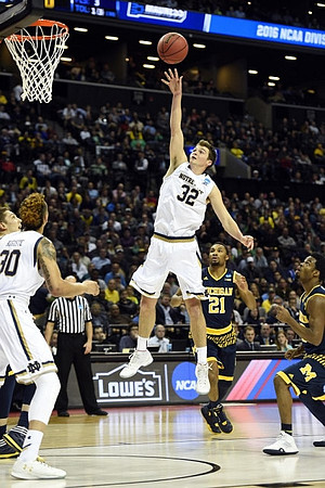Mark Donnal (34), Zak Irvin (21), and Derrick Walton Jr. (10)