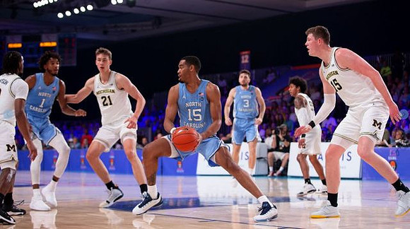 Zavier Simpson (3), Franz Wagner (21), Eli Brooks (55), and Jon Teske (15)