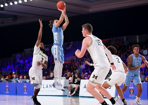 Zavier Simpson (3), Jon Teske (15), and Isaiah Livers (2)