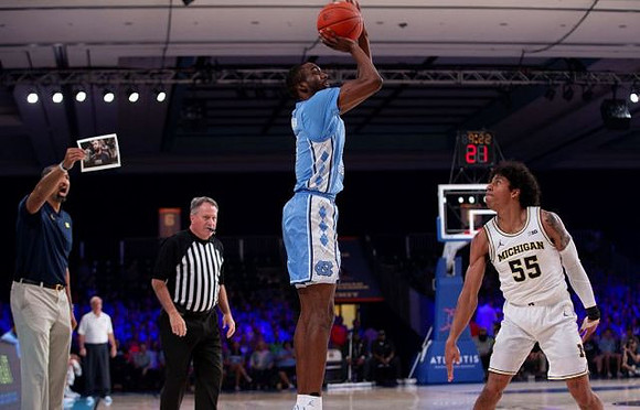 North Carolina Head Coach Roy Williams, Juwan Howard, and Eli Brooks (55)