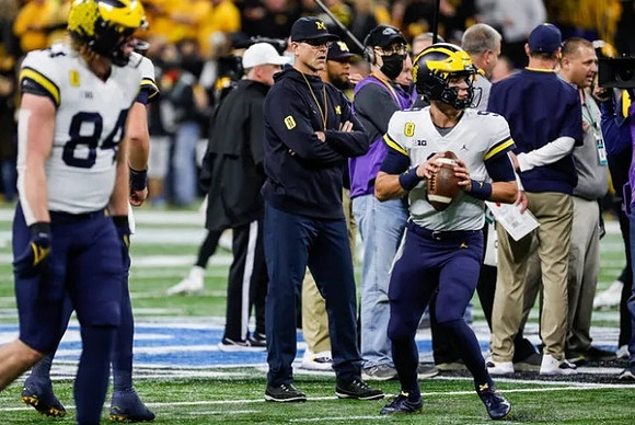 Joel Honigford (84), Jim Harbaugh, and J.J. McCarthy (9)