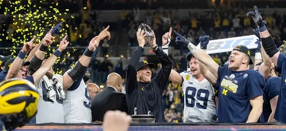 Andrew Vastardis (68), Donovan Jeter (95), Jim Harbaugh, Carter Selzer (89), Aidan Hutchinson (97), and Big Ten Conference Championship Trophy