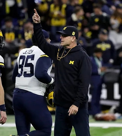 Donovan Jeter (95) and Jim Harbaugh