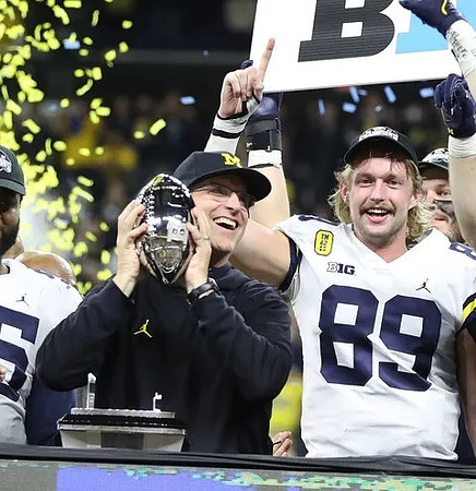 Jim Harbaugh, Carter Selzer (89), and Big Ten Conference Championship Trophy